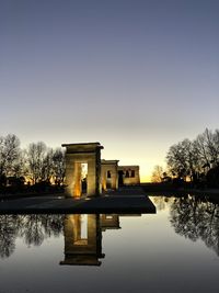 Reflection of building in lake during sunset