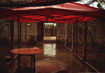 Empty chair against red wall