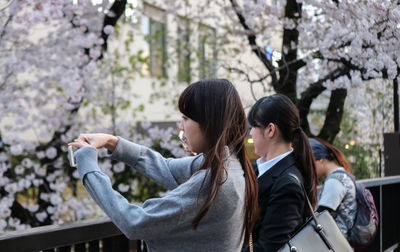 Rear view of women and daughter on tree