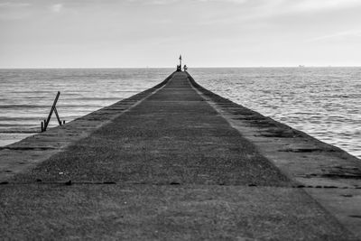 Pier over sea against sky