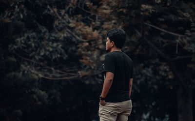 Rear view of man looking at forest