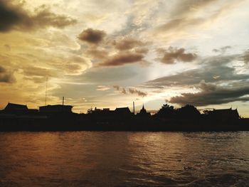 Silhouette buildings against sky during sunset