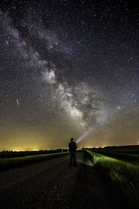 Full length of man standing on road at night