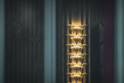 Close-up of illuminated electric lamp on wall