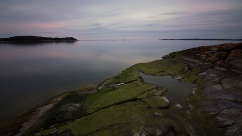 Scenic view of sea against cloudy sky