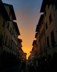 Buildings in city at sunset