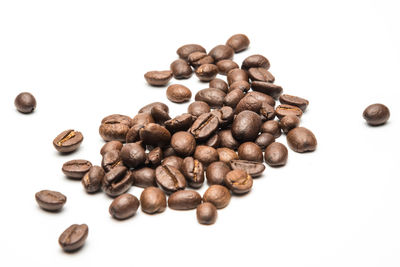 High angle view of coffee beans against white background