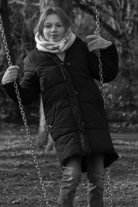 Full length portrait of a girl on swing