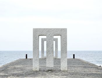 Built structure on beach against clear sky