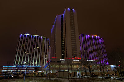 Low angle view of illuminated buildings against sky at night