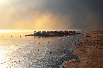 Scenic view of beach against sky during sunset