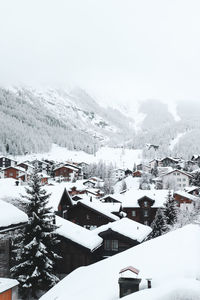 High angle view of snow covered houses in village