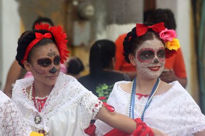 Portrait of young woman with red mask