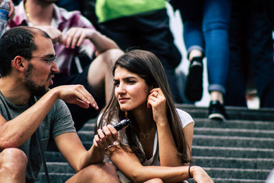 Young couple sitting in park