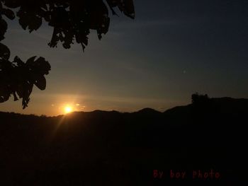 Scenic view of silhouette mountains against sky at sunset