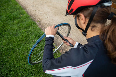 High angle view of athlete repairing tire