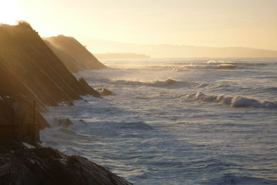 Scenic view of sea against clear sky during sunset