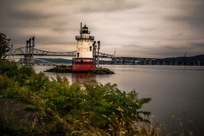 View of bridge over river against cloudy sky