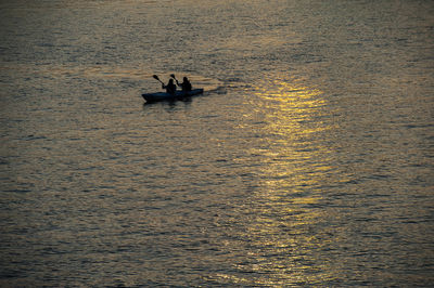 Silhouette of nautical vessel on sea against sky