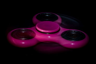 Close-up of pink water over black background