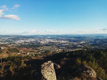 Aerial view of landscape against blue sky