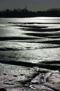 Scenic view of beach against sky during winter
