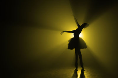 Silhouette ballet dancer dancing on stage