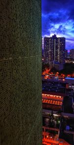 Low angle view of illuminated buildings against sky at night