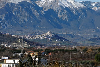 High angle view of townscape and snowcapped mountains