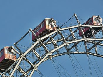 High section of ferris wheel against clear blue sky