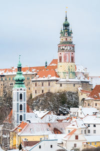 Tower amidst buildings in city against sky