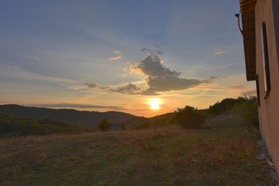 Scenic view of field against sky during sunset