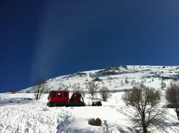 Snow covered mountain against blue sky