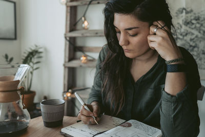 Woman making notes in diary