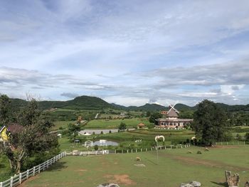 Scenic view of trees and buildings against sky