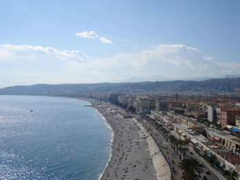 High angle view of city buildings against cloudy sky