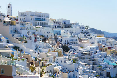 Buildings in city against clear sky