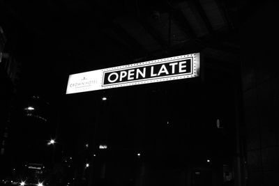 Low angle view of information sign at night