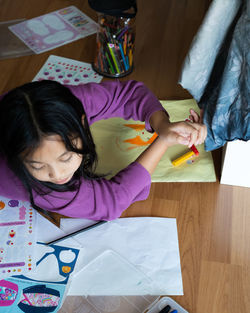 High angle view of girl sitting at home