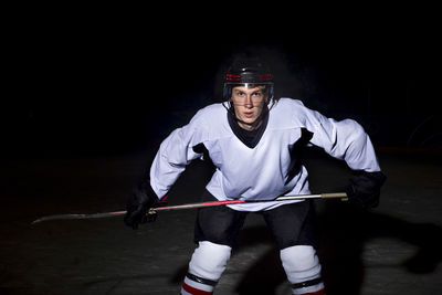 Portrait of young man playing ice hockey