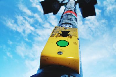 Low angle view of road sign against blue sky