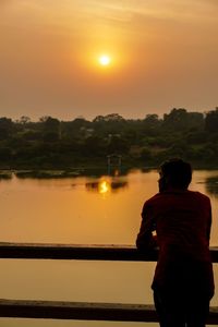 Indian boy in show sunset