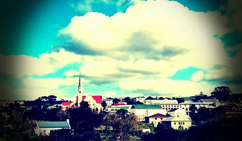 Residential buildings against cloudy sky