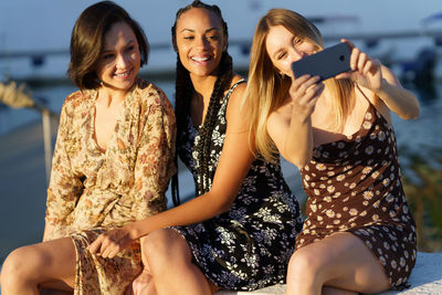 Smiling females taking selfie outdoors