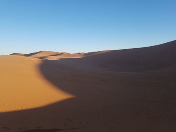 Scenic view of desert against clear sky