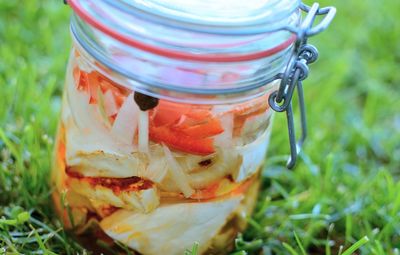 Close-up of drink in glass jar on grass