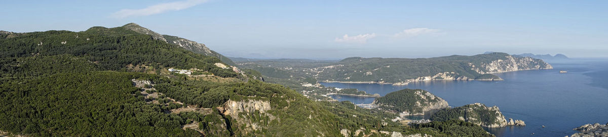 Panoramic view of sea and mountains against sky