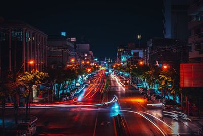 Illuminated city street at night