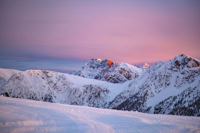 Scenic view of snowcapped mountains against sky during sunset