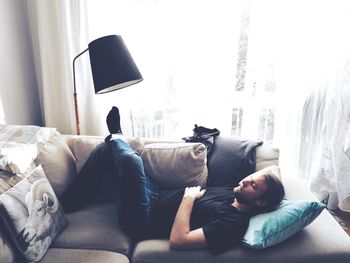Mid adult man sleeping sofa at home
